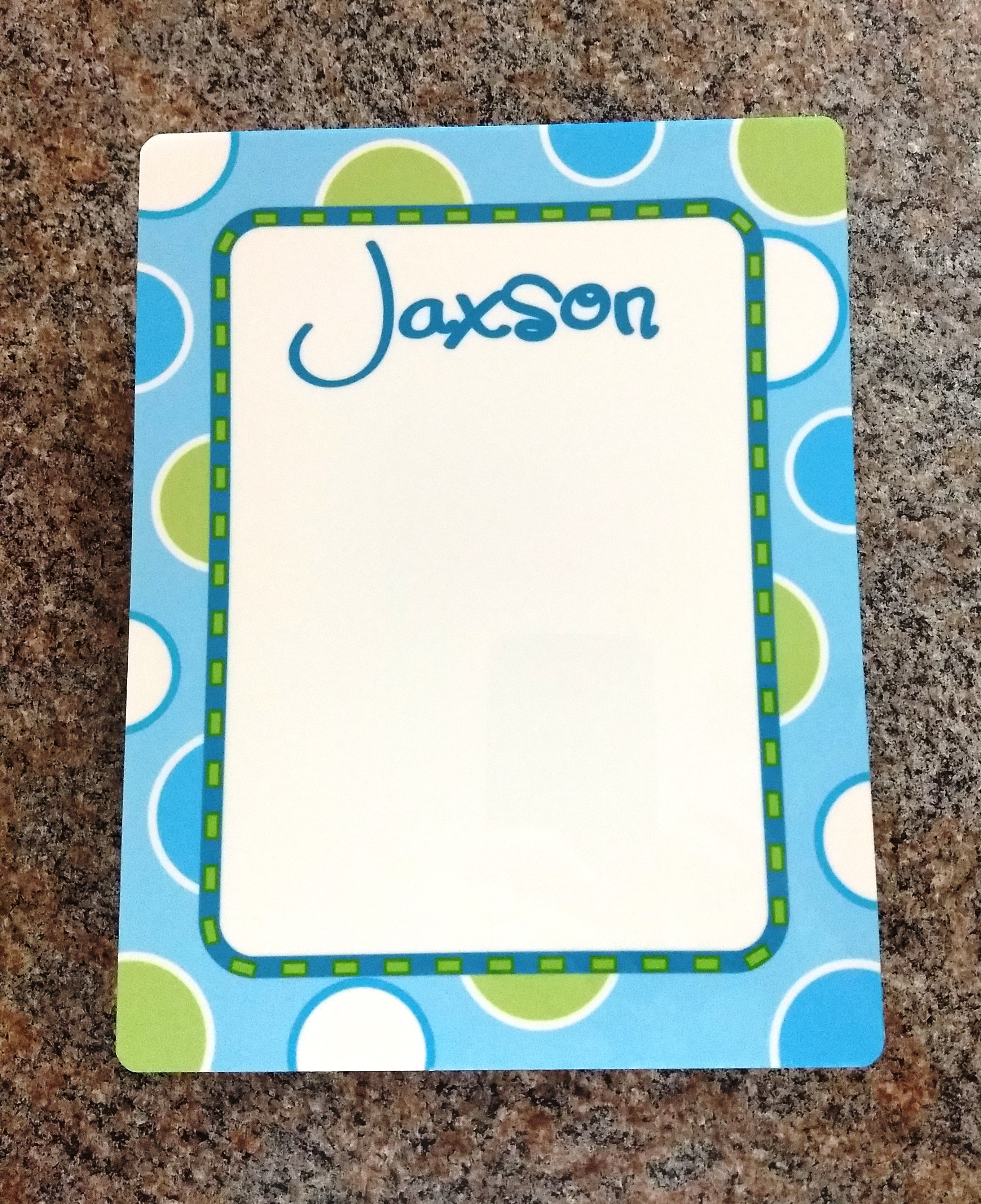 dry erase board with multi colored dots with boys name