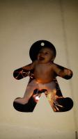 Baby in Christmas lights on the Gingerbread Man Ornament