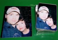 Glossy puzzle of a Mother and her son with a tin to match.