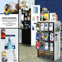 My display of custom, personalized and ready-to-buy door hangers at a conference for members of