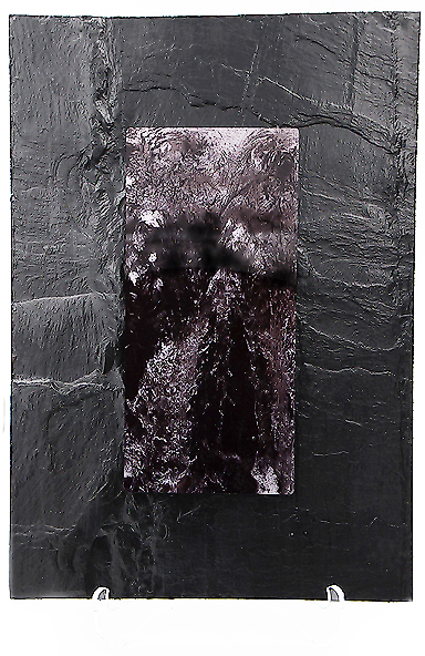 Black & White Image hovering over heavy, textured slate. Glacial rocks create sonorous bubbling