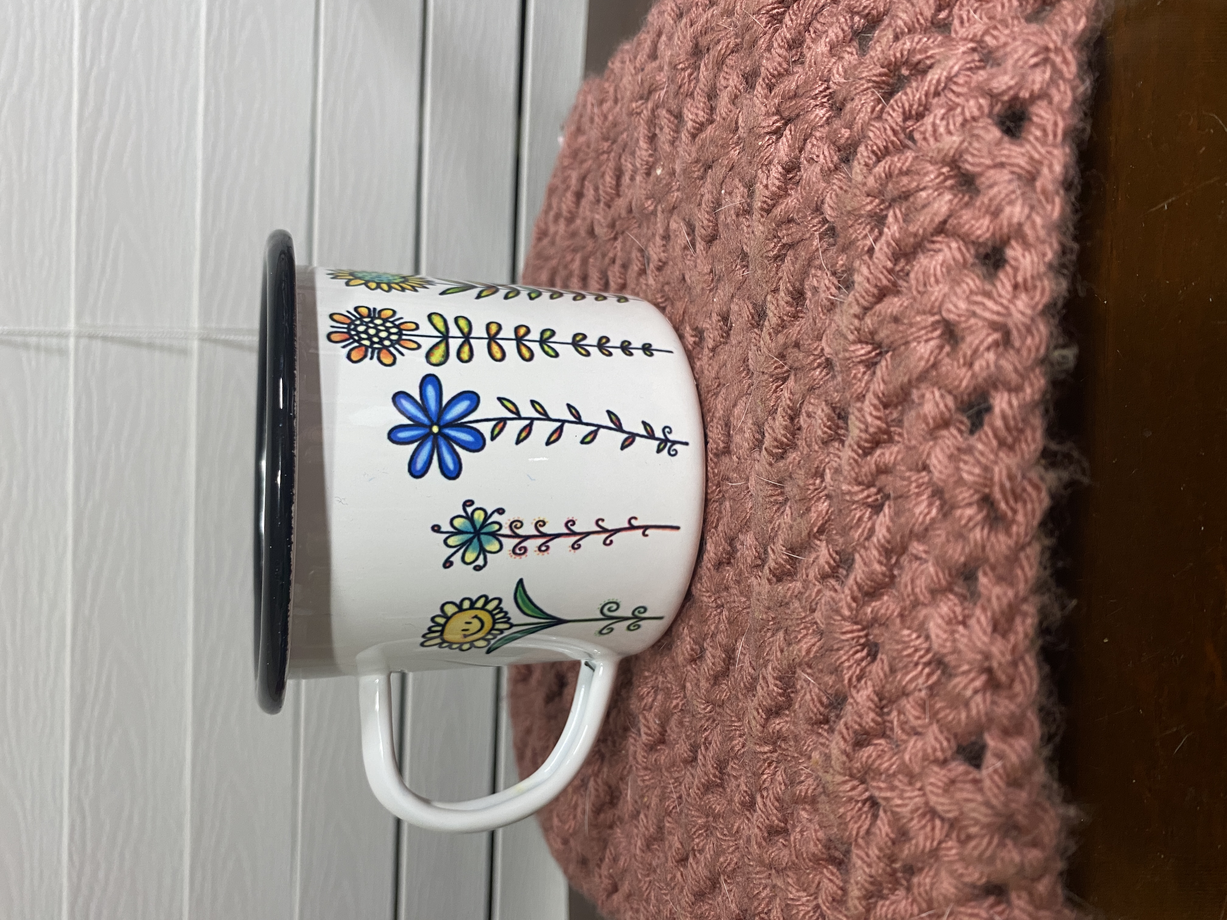 Adorable and bright wildflowers printed on a white stainless and enamel camp cup