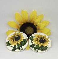 A couple of car coasters with a vintage sunflower image.