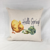 Pillow displays image of a tiny yellow chicky pulling ribbon wrapped around a hydrangea. Creati