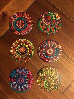 Coaster set with Creative Studio Boho Chic image designs. Photographed against dining room tabl