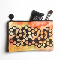 Linen cosmetic bag with watercolor background and honey bee design.
