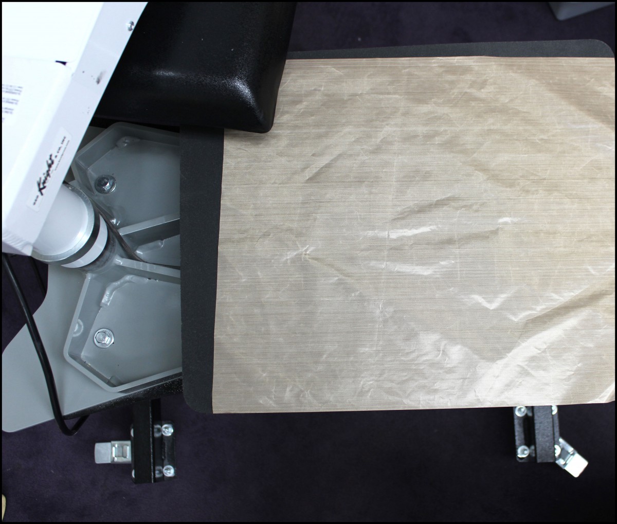 5. Cover bottom table of heat press with Teflon.